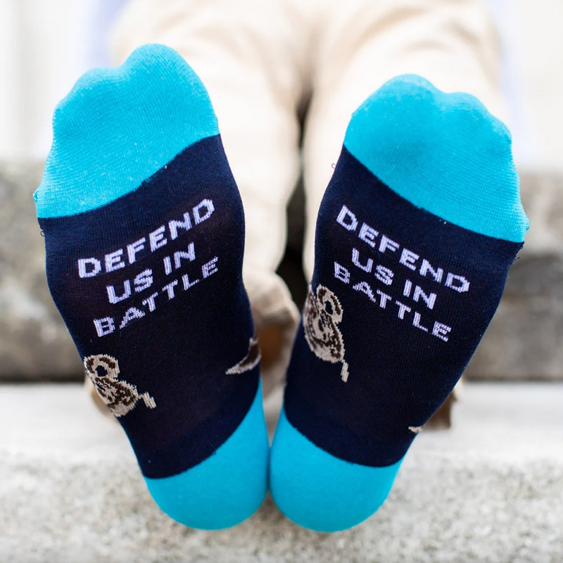 Person wearing blue socks featuring an image of St. Michael the Archangel