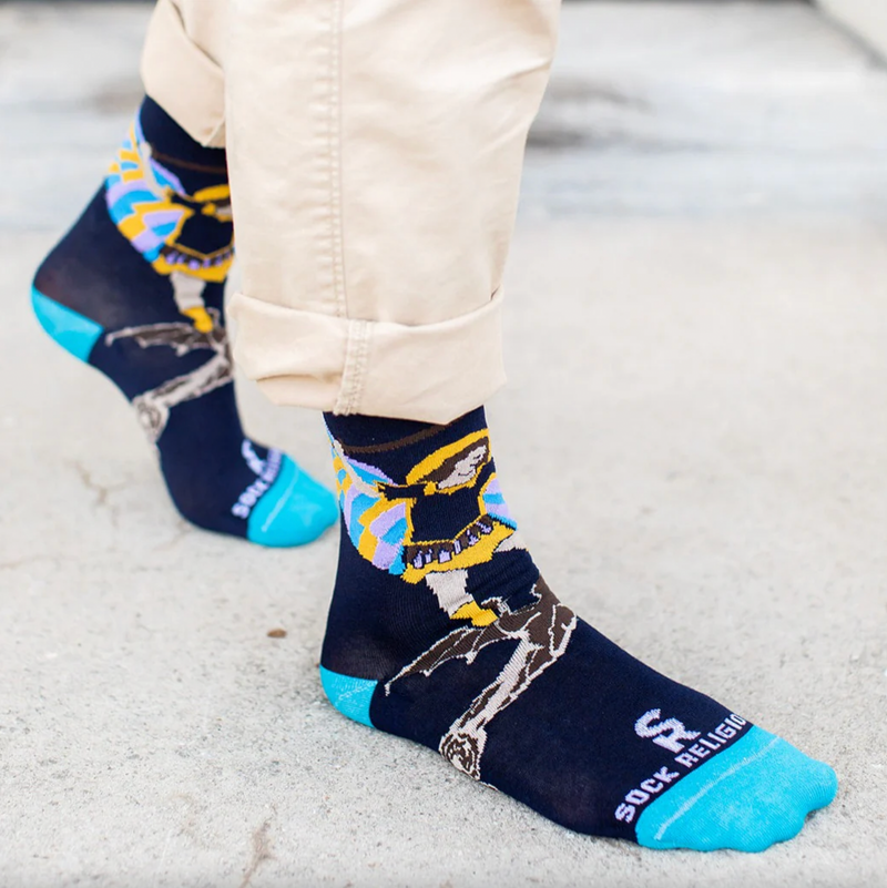 Person wearing blue socks featuring an image of St. Michael the Archangel