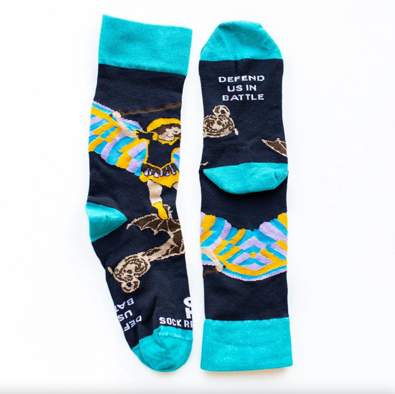Person wearing blue socks featuring an image of St. Michael the Archangel