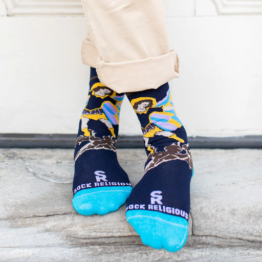 Person wearing blue socks featuring an image of St. Michael the Archangel