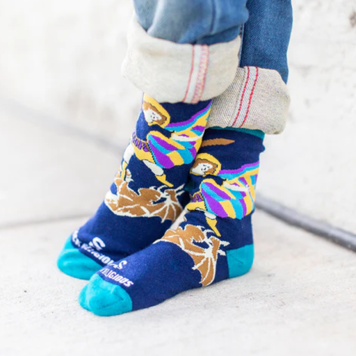Colorful socks with images of St. Michael the Archangel worn by a child on a light background