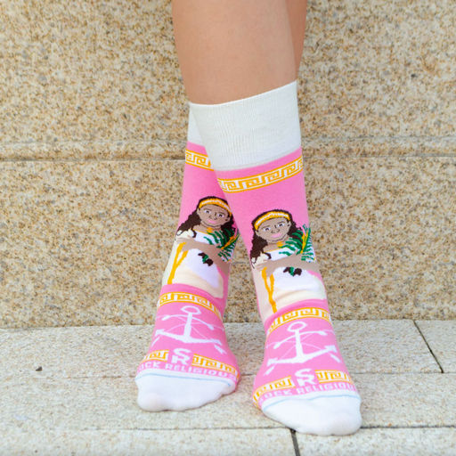Person wearing pink and gold socks featuring an image of St. Philomena holding a palm branch