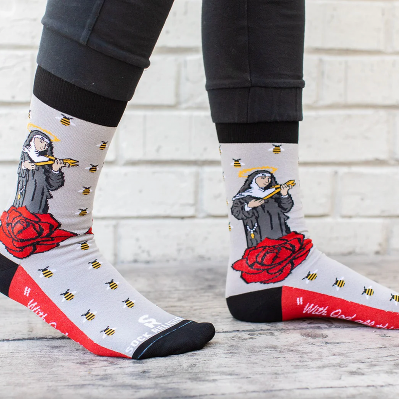 Person wearing gray socks with vibrant red roses and an image of St. Rita holding a cross.