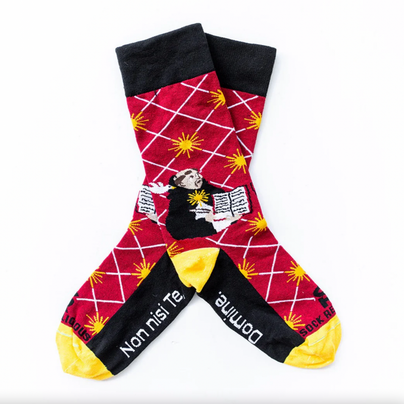 A pair of adult-sized socks with a colorful geometric pattern and an illustration of St. Thomas Aquinas in the center.