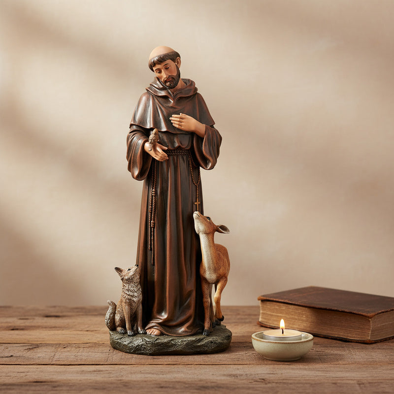 St. Francis of Assisi with animals statue on a wood surface.