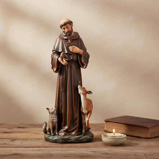 St. Francis of Assisi with animals statue on a wood surface.