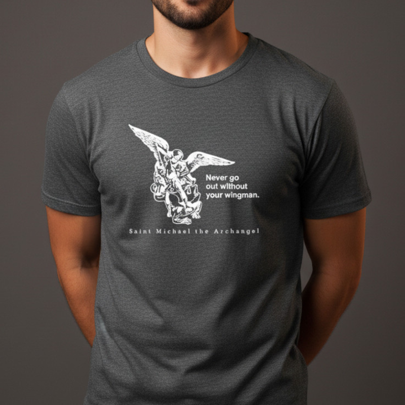 Dark gray t-shirt with white graphic of St. Michael the Archangel worn by a person on a dark background