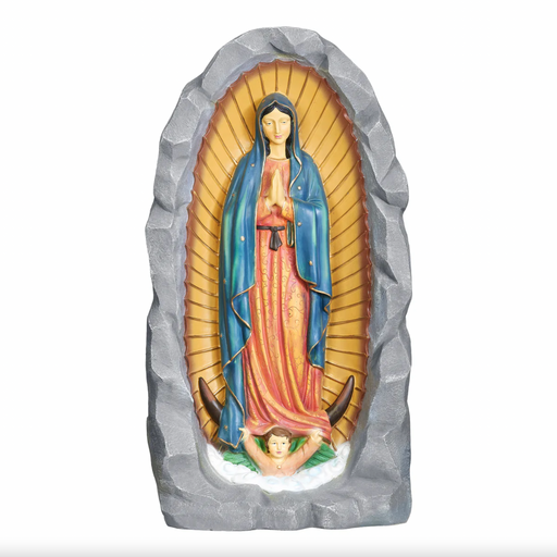 Statue of Our Lady of Guadalupe in a stone niche on a white background
