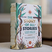 Book titled 'The Story of All Stories' for young Catholics on a blurred background