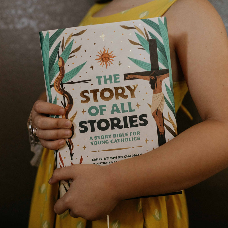 Person holding a book titled 'The Story of All Stories' by Emily Simpson Chapman.