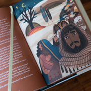 Illustrated book open to a page with characters and text