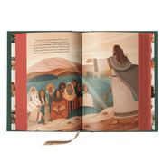 Open book with illustrated pages showing a religious scene with figures and landscape.