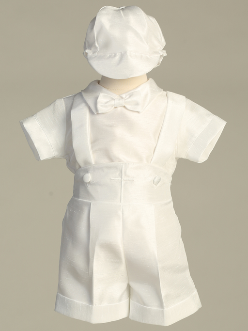 White baby baptism outfit with shirt, bow tie, and hat on a beige background