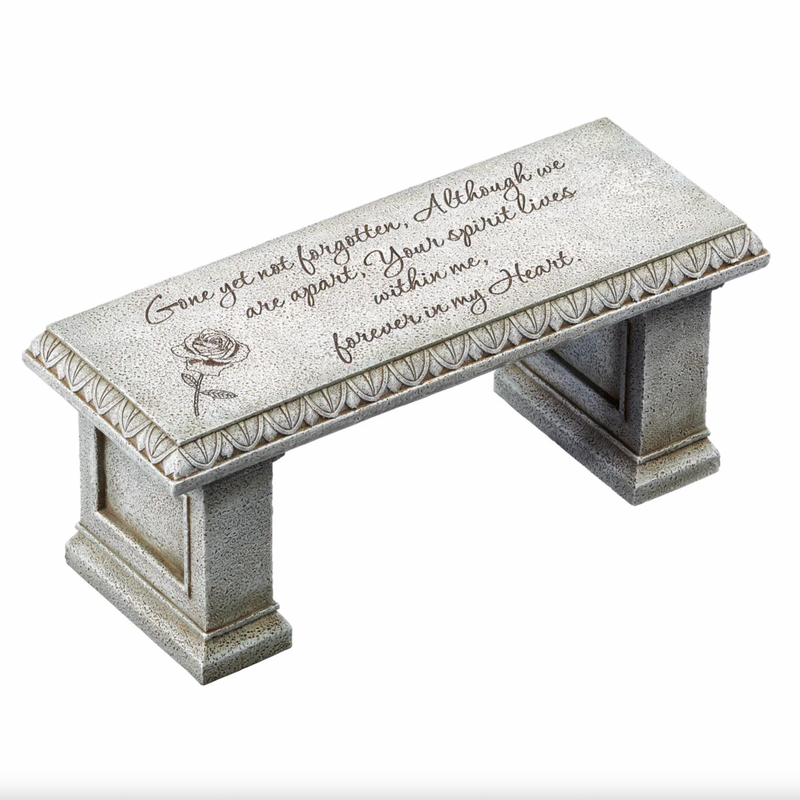 Memorial bench with engraved text and rose design on a white background