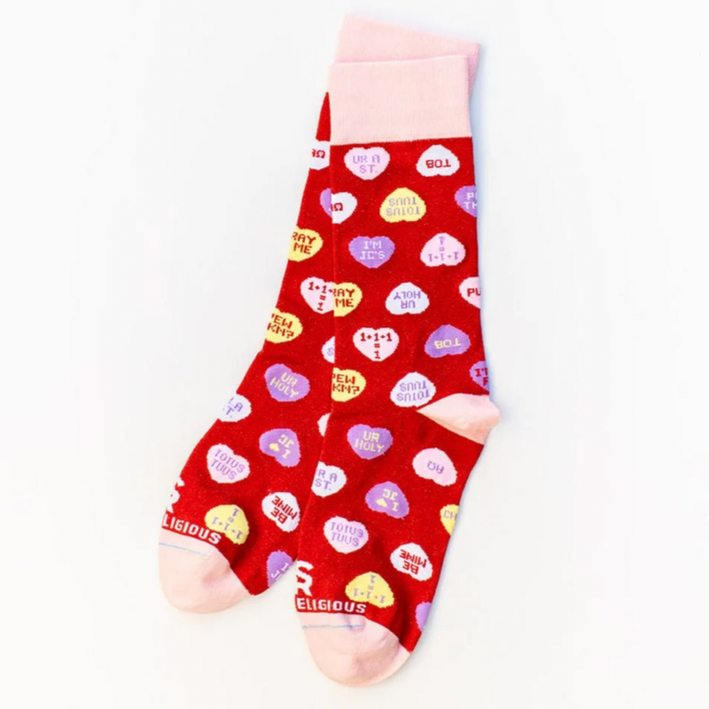 Red socks with red candy hearts and witty Christian puns on a white background