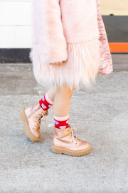 Child wearing red socks with candy hearts featuring witty Christian sayings