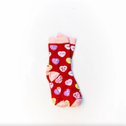Red socks with candy hearts featuring witty Christian sayings