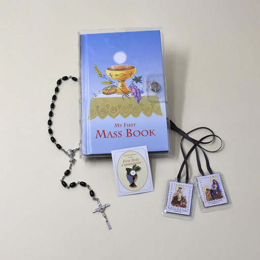 My First Mass Book with rosary and prayer cards on a light background