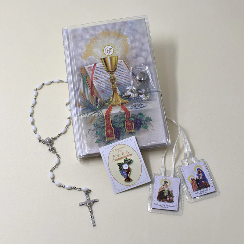 Rosary, prayer book, and holy cards on a light background