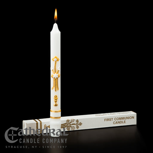 White candle with gold designs and packaging labeled 'First Communion Candle' from Cathedral Candle Company on a black background.