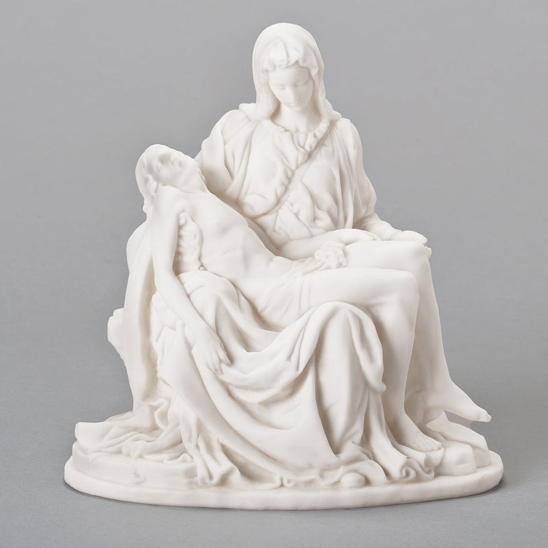 White sculpture of the Pieta on a gray background