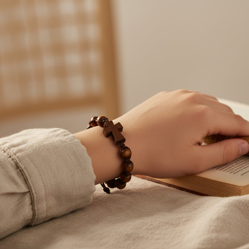 Hand wearing a wooden bracelet on a book with a blurred background