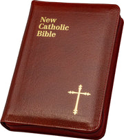 Red New Catholic Bible with gold text and cross on a white background