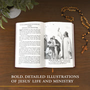 Open book with illustrations of Jesus' life on a wooden surface with a plant and rosary.