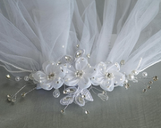 2nd extreme close-up on the floral details of a little girl's white sheer First Communion veil