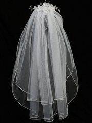 Full view of a little girl's white sheer First Communion veil