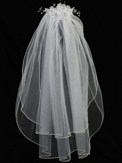 Full view of a little girl's white sheer First Communion veil
