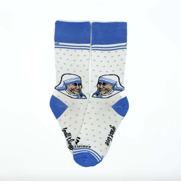 A person in white socks with blue accents and an image of Mother Teresa