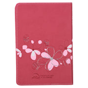 Pink Bible with floral designs and 'Holy Bible King James Version' text on a white background