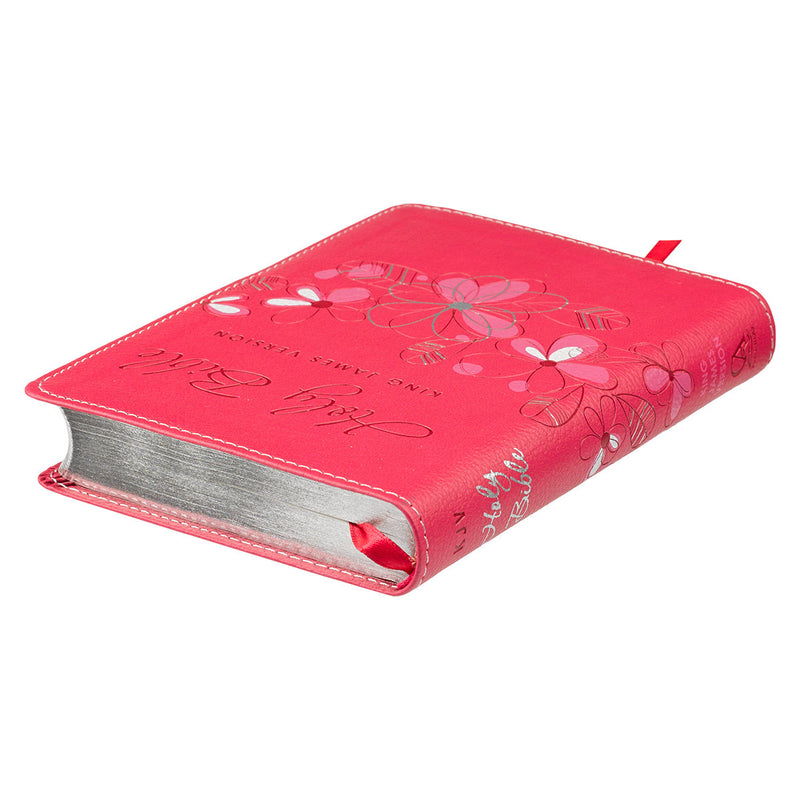 Pink Bible with floral designs and 'Holy Bible King James Version' text on a white background