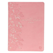 A pink faux leather Bible with a debossed floral design on the cover and the title 'The Spiritual Growth Bible Pink' printed in gold.