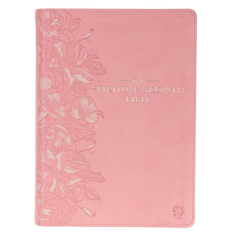 A pink faux leather Bible with a debossed floral design on the cover and the title 'The Spiritual Growth Bible Pink' printed in gold.