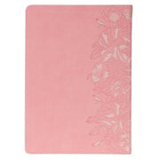 A pink faux leather Bible on a white background.