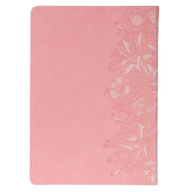 A pink faux leather Bible on a white background.
