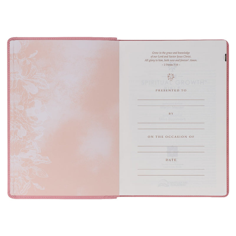 A pink faux leather Bible won a white background.