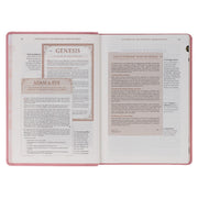 A pink faux leather Bible won a white background.