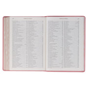 A pink faux leather Bible won a white background.