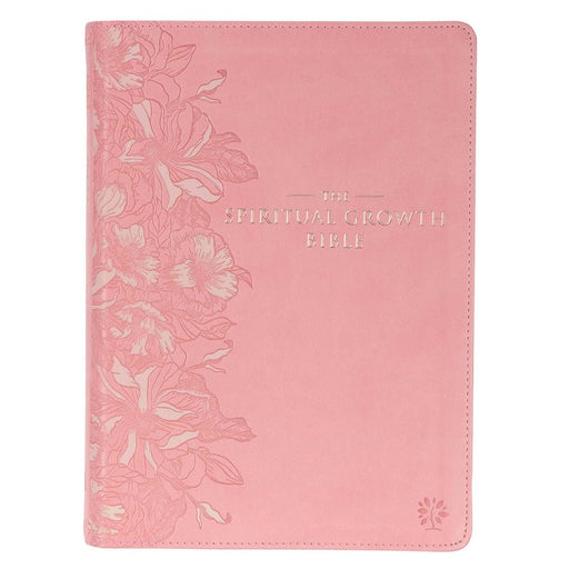 A pink faux leather Bible with a debossed floral design on the cover and the title 'The Spiritual Growth Bible Pink' printed in gold.
