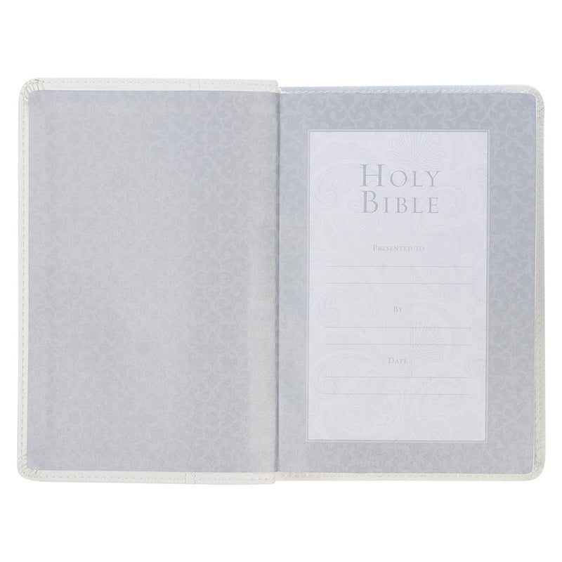 A white faux leather compact Bible with a quatrefoil floral design on a white background.