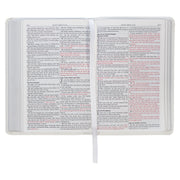 A white faux leather compact Bible with red letter text.