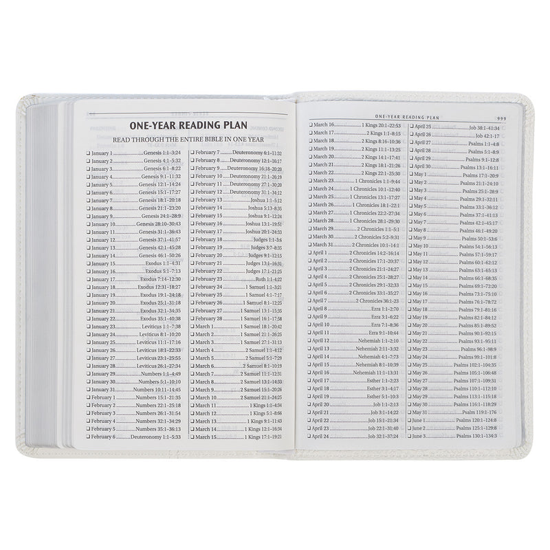 A white faux leather compact Bible with a one-year reading plan text.